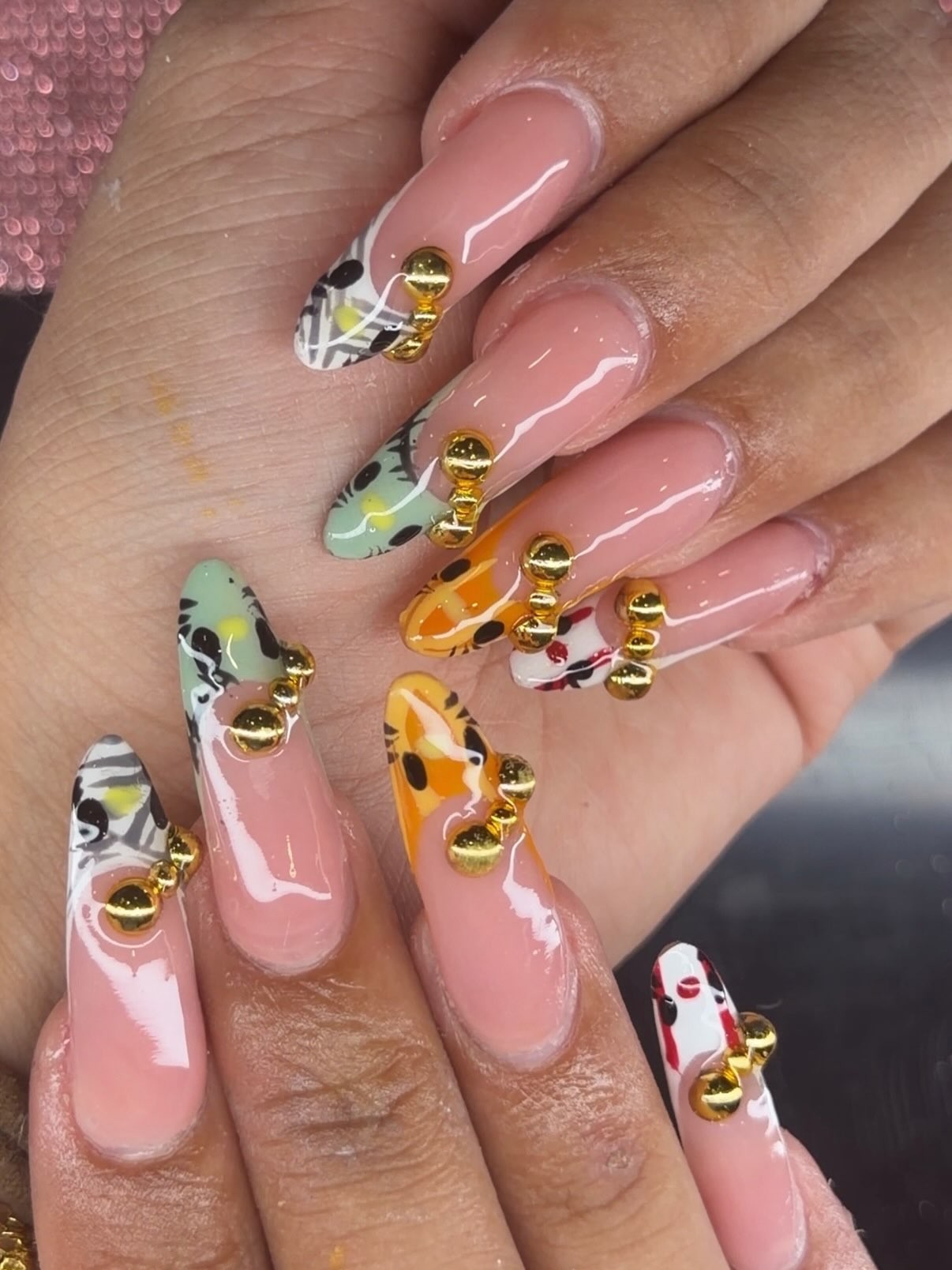 Pink acrylic nails with intricate details